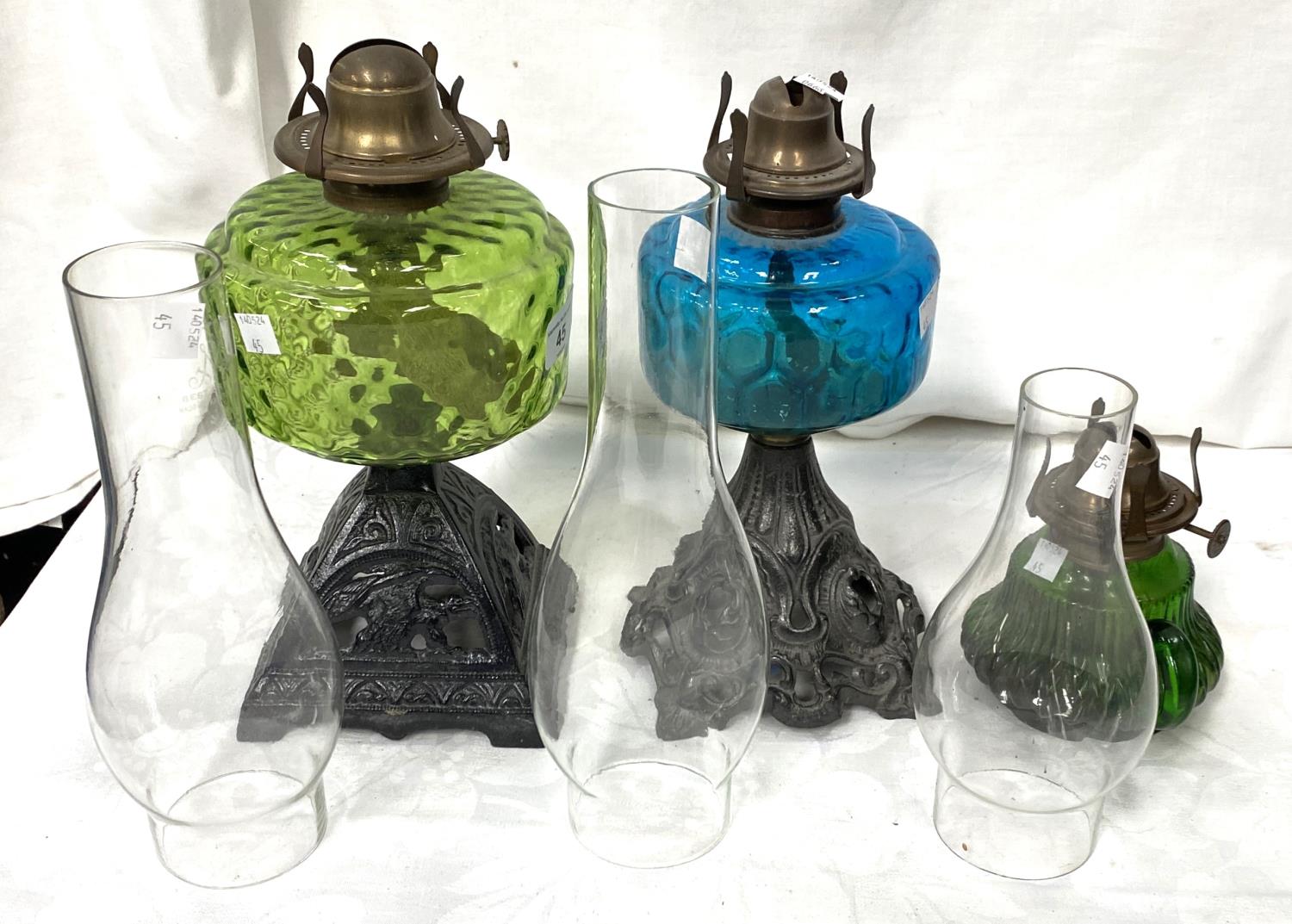 Two Victorian cast iron and coloured glass oil lamps and a smaller lamp - Image 2 of 2