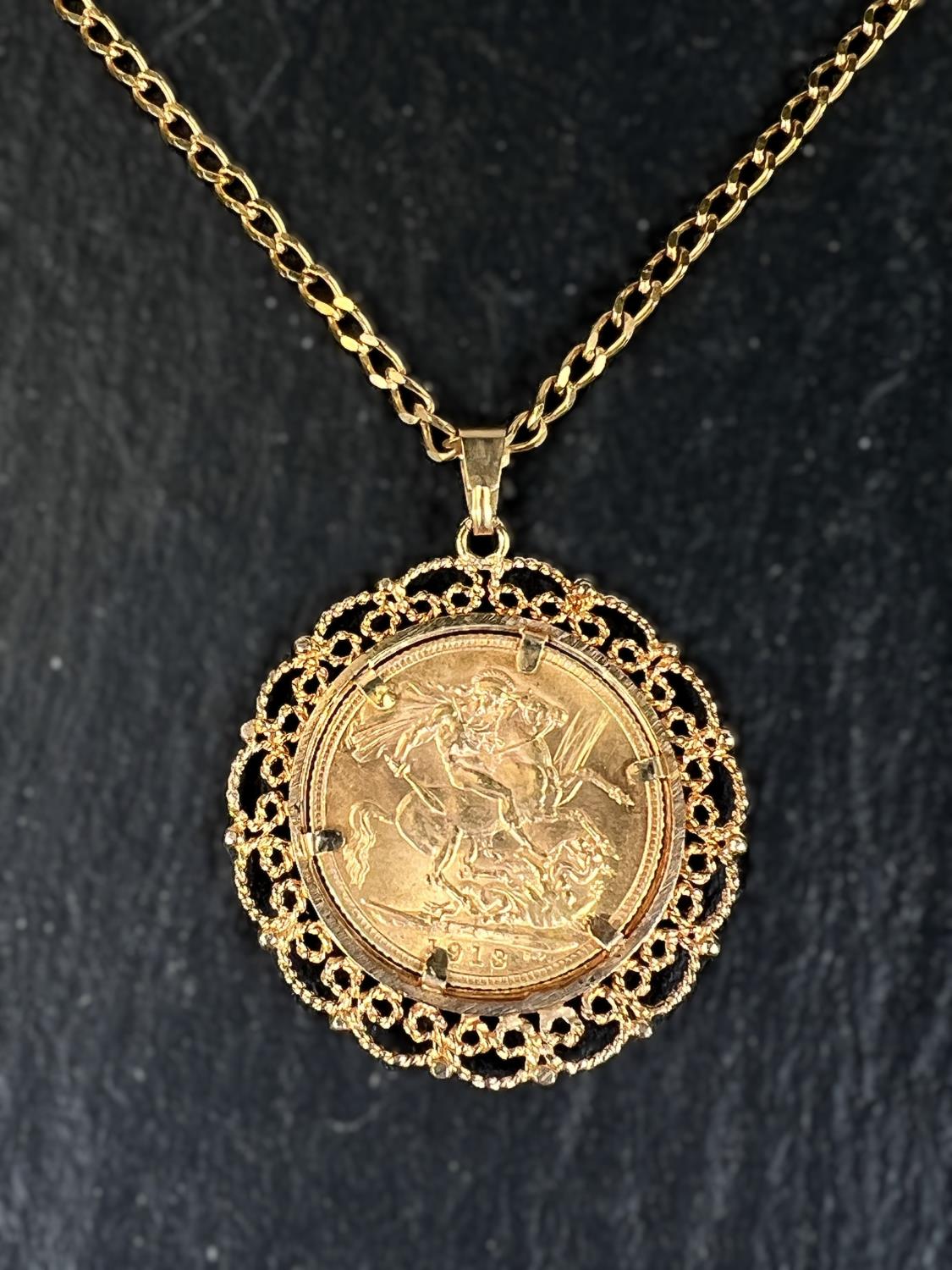 A George V sovereign in filigree pendant mount, on flattened curb chain, gross 18gm - Image 2 of 2
