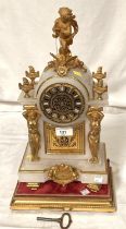 A Louis XVI style white marble mantle clock with gilt metal cherub finial and mounts with base and