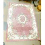 An Indian rug with floral pattern against a pink ground, 285 x 200cm