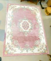 An Indian rug with floral pattern against a pink ground, 285 x 200cm
