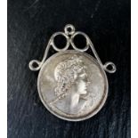 A hallmarked silver musical medal, Apollo and his lyre to the front and inscription Bute Cumbrae and