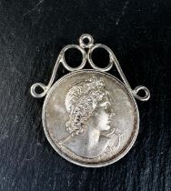 A hallmarked silver musical medal, Apollo and his lyre to the front and inscription Bute Cumbrae and
