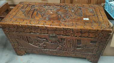 An oriental camphor wood bedding box with extensive carved wood decoration, length