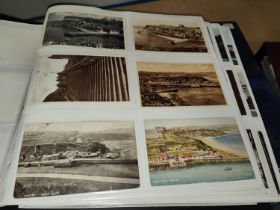 A large album of early and later 20th century post cards, seaside views and towns