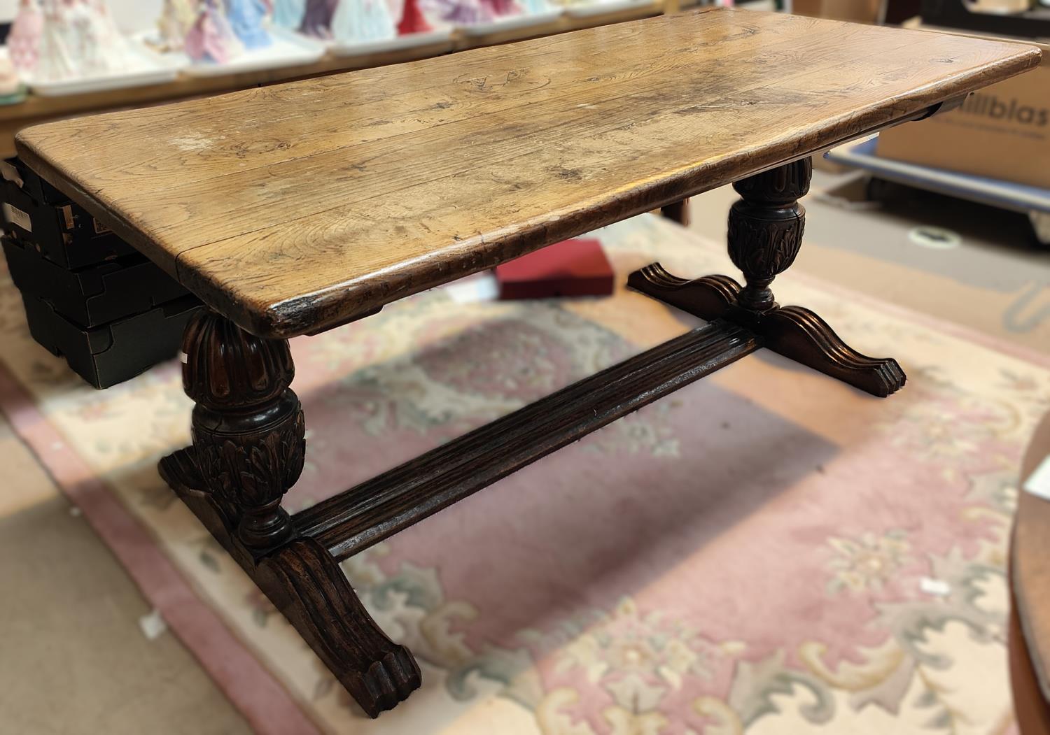 A large Elizabethan style refectory dining table with thick plank top and carved bulbous legs,