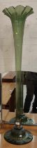 A large floor standing trumpet vase in green glass, 124cm