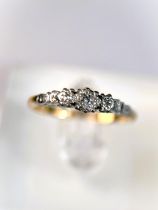 An 18 carat hallmarked gold dress ring with 3 illusion set diamonds in platinum surround, 2.5gm,