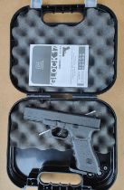 A modern Glock 17 air pistol in case with instructions