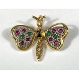 An 18ct gold pendant in the form of a butterfly set with multicoloured stones