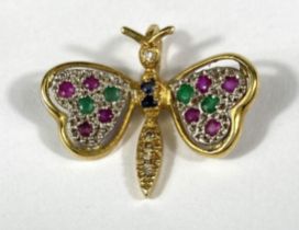 An 18ct gold pendant in the form of a butterfly set with multicoloured stones