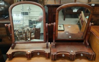 A Victorian pair of mahogany free standing dressing table mirrors with drawers to the base
