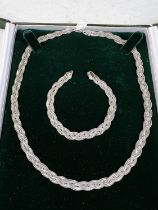 A plaited white metal neck chain and bracelet stamped 375. 21gm
