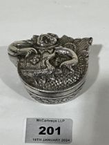 An early 20th Century Chinese white metal box, the cover moulded in relief with a chimera. 3" wide