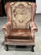An upholstered wing armchair.