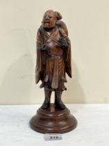 A 19th century carved hardwood figure of a sage. 11" high.