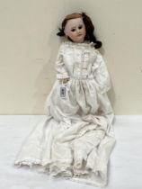 An early 20th Century German doll, the bisque head with brunette wig (A.F.), sleeping eyes and