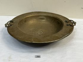 An Islamic two handled brass bowl 21" diam