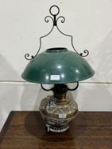 A brass hanging lamp with enamel shade.