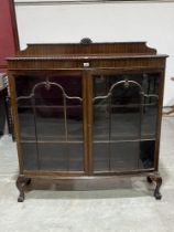 A 1920s mahogany bow fronted display cabinet on cabriole legs. 48" wide.