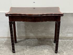 A 19th century mahogany and crossbanded serpentine card table with small drawer to the back panel,