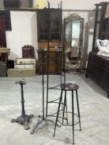 A wrought iron pan stand and three other items of cast or wrought metalware (4)