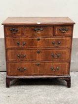 A George II walnut and line inlaid chest, the moulded top over three short and three long