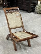 A rosewood folding chair with caned back and seat