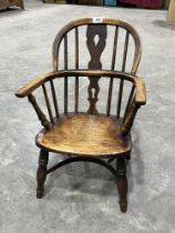 A 19th Century Windsor child"s chair with crinoline stretcher. 25" high. The seat side bearing stamp