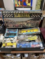 A boxed collection of Scalextric racing cars and accessories.