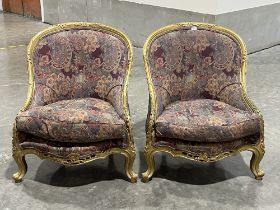 A pair of giltwood and upholstered chairs in the French taste.