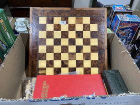 A wooden chess set; another board and chess pieces.