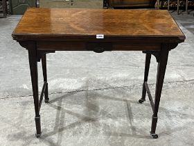 An Edward VII rosewood card table on square tapered legs. 36" wide. Stretchers lacking.