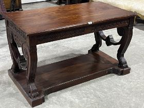 An Asian hardwood side table on double scroll end supports with carved paw feet. 47" wide