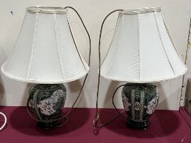 A pair of ceramic based table lamps.