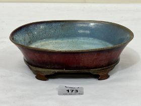 A Chinese red glazed oval footed bowl with crackle glazed blue interior. 8" wide.