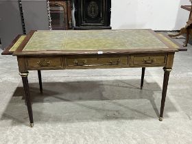 A mahogany writing table with applied gilt brass mounts, the tooled leather inlet top over three