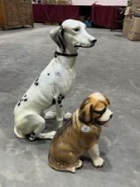 A composition model of a seated dalmatian, 27" high and a smaller ceramic St. Bernard.