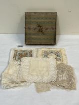 A box of silk squares and lace.