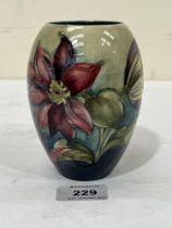 A Moorcroft ovoid vase with tube lined decoration of flowers 5" high.