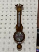 An aneroid barometer by O. Comitti and Son with inlaid mahogany case. 26" high