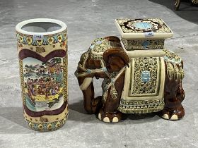 An oriental style glazed ceramic elephant garden seat, 17" high; together with a stick stand.