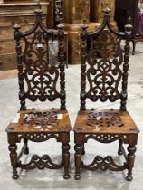 A pair of Victorian gothic oak high back side chairs with tracery carved backs. (A.F.)