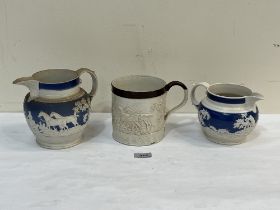 Two Victorian blue and white sprigged jugs and a large salt glazed mug moulded with a continuous