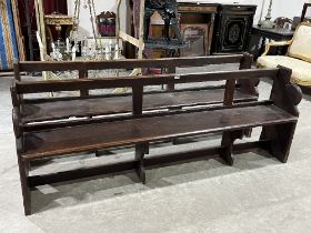 A pair of stained pine church pews. 74" wide