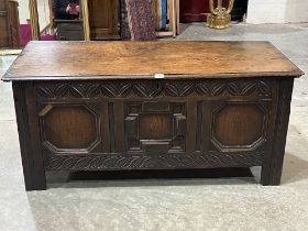 A late 17th Century joined oak chest, the three panel geometrical front with leaf carved borders,