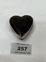 A tortoiseshell and silver mounted heart shaped box. engraved initials and date 1926. 2" long.