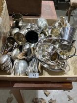 A box of cutlery and other platedware.