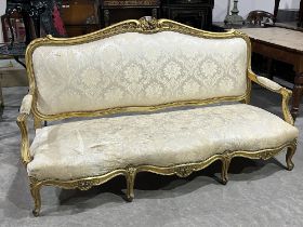 An early 20th century giltwood sofa in the French taste, with open arms, on cabriole legs. 75"