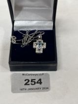 A 9ct white gold aquamarine and diamond cross pendant on 9ct necklet chain. 3.8g gross.